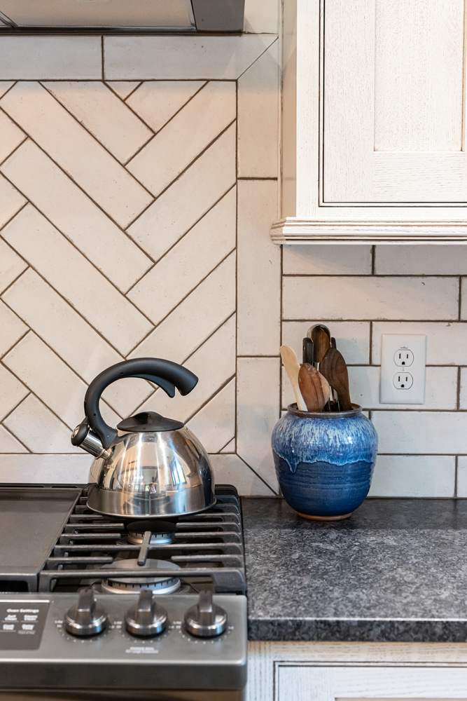 Custom backsplash detail with modern finishes by Kaizen Homes in Black Mountain, NC