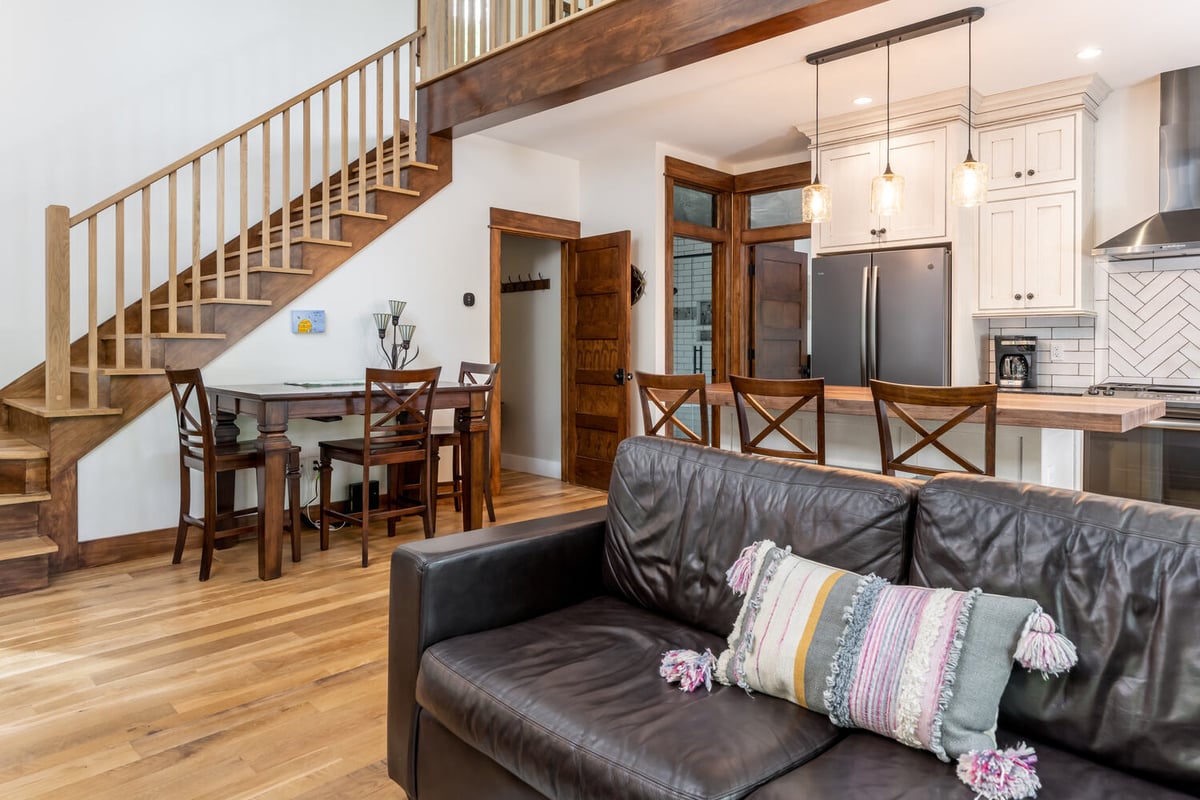 Custom living room and kitchen space with staircase view by Kaizen Homes in Marshal