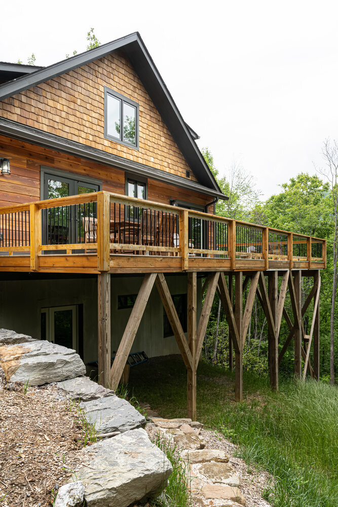 Detailed view of cabins foundation and support structure by Kaizen Homes
