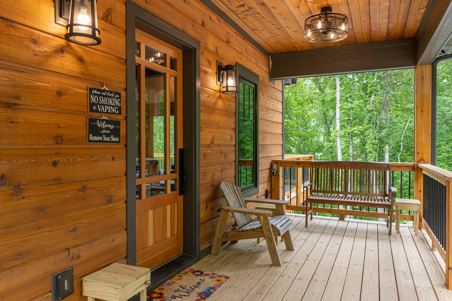 Inviting front entry porch surrounded by forest views in a Kaizen Homes home