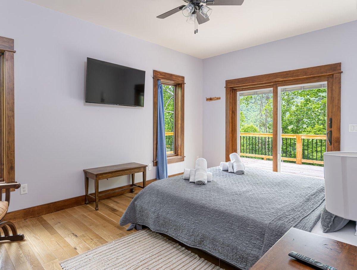 Peaceful bedroom retreat opening to deck in a Kaizen Homes custom home in Montreat
