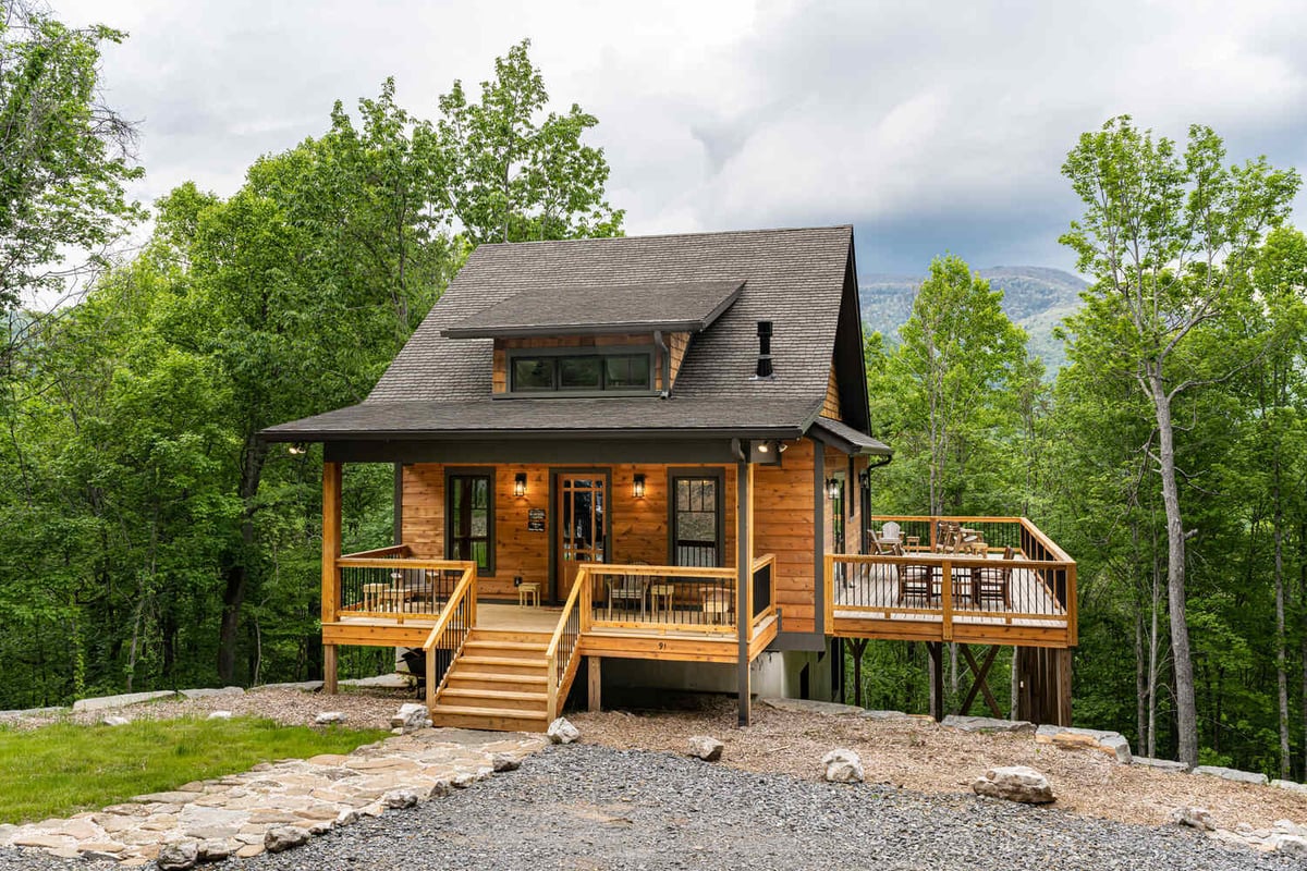 Rustic mountain retreat with spacious wooden deck built by Kaizen Homes in Fairview