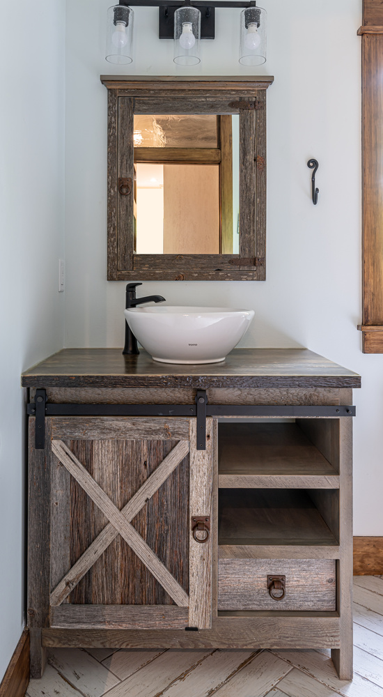 Rustic wood vanity with vessel sink in custom home by Kaizen Homes in Marshall, NC