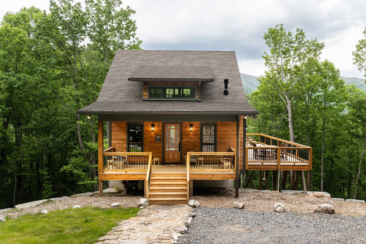 Scenic view of Kaizen Homes cabin nestled in lush forest near Woodfin, NC