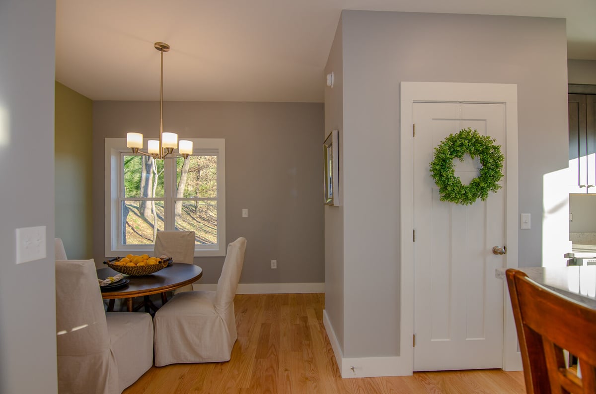 Custom dining space with modern lighting by Kaizen Homes in Canton, NC