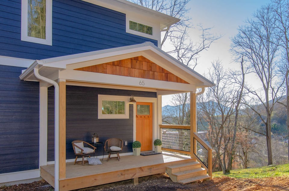 Elevated front porch and bold blue exterior on Kaizen Homes custom home in Canton NC