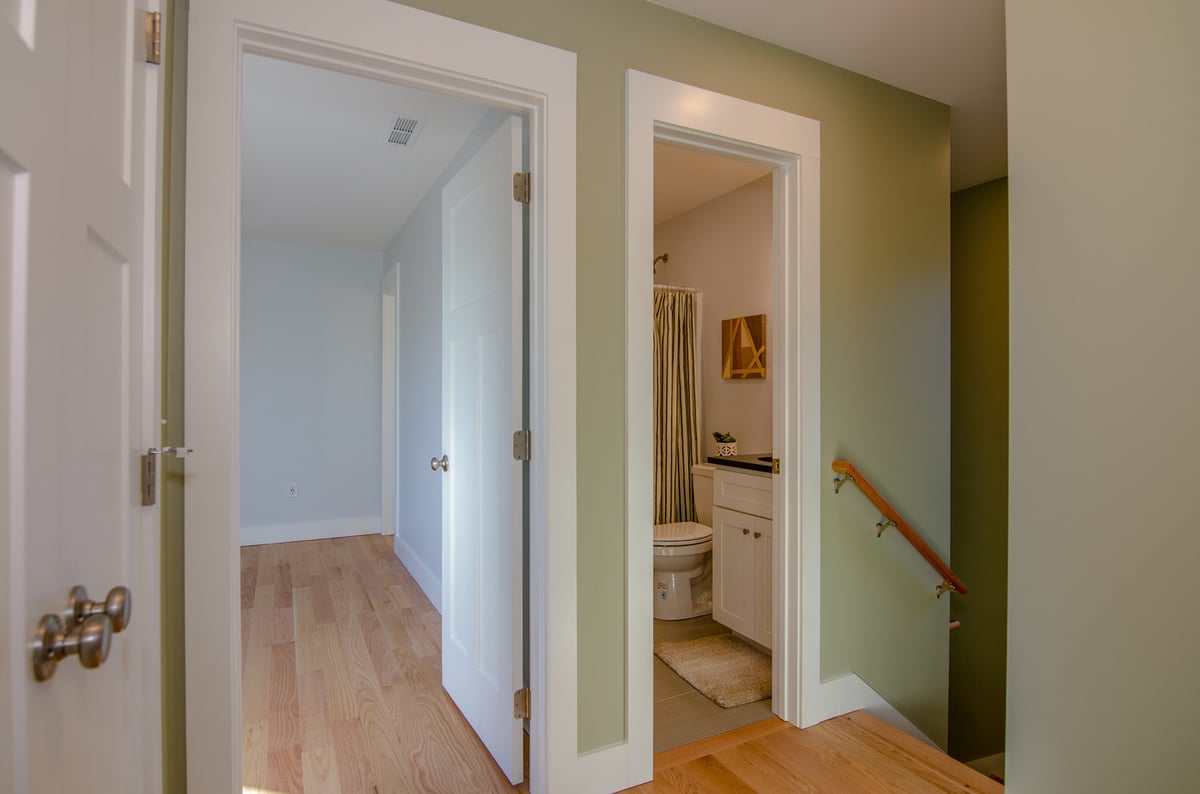 Upper hallway and bathroom in a Canton, NC custom home by Kaizen Homes