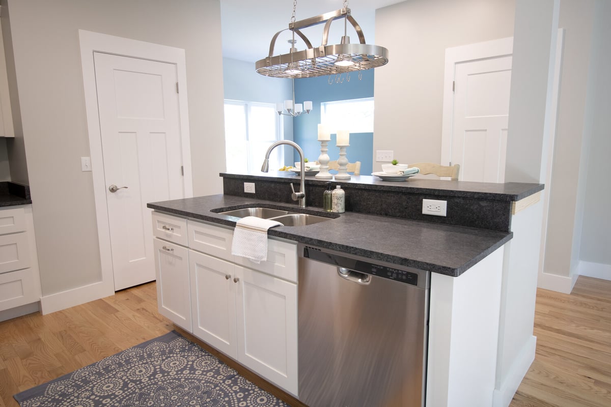 Custom kitchen island with stainless steel sink in a Kaizen Homes build in Canton, NC