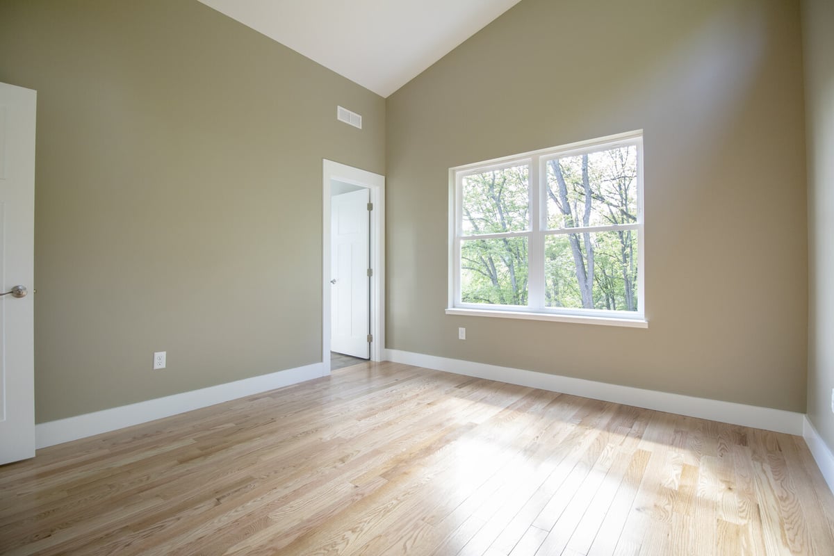 Light-filled master bedroom with hardwood flooring in a Kaizen Homes build, Canton, NC