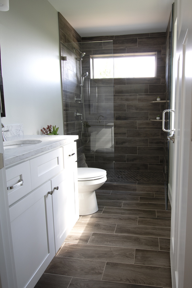 Modern master bathroom with walk-in shower and tile flooring by Kaizen Homes in Canton