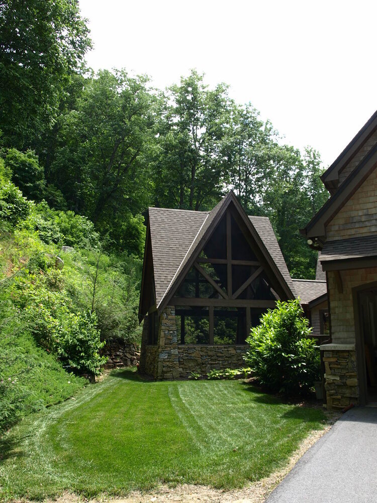 Expansive lawn and windowed addition of custom home by Kaizen Homes in Montreat, NC