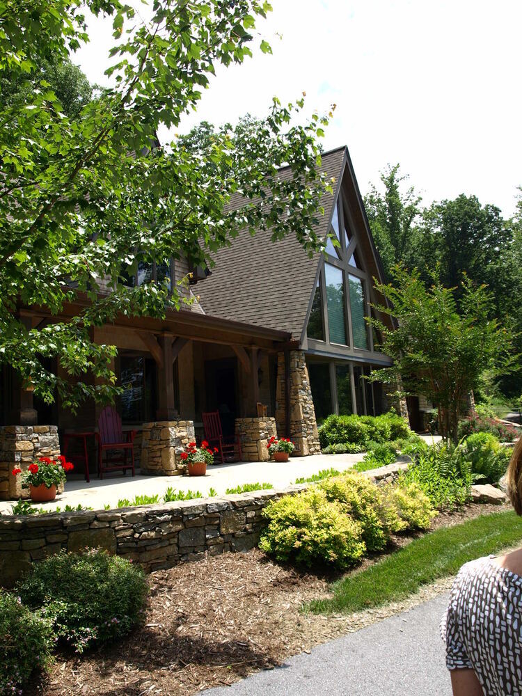 Garden landscape and inviting porch of custom home by Kaizen Homes in Mills River NC