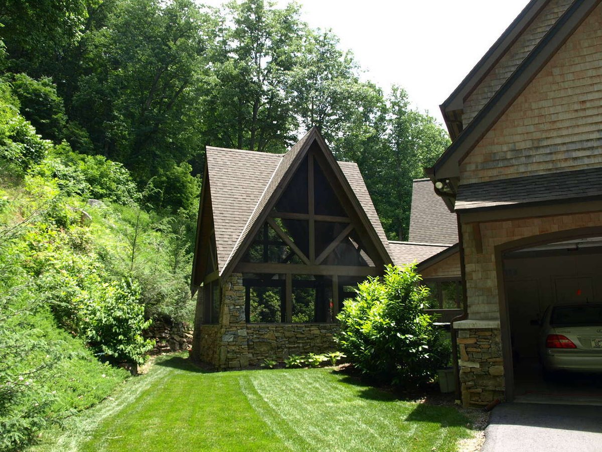 Private backyard view of custom home by Kaizen Homes in Old Fort, NC