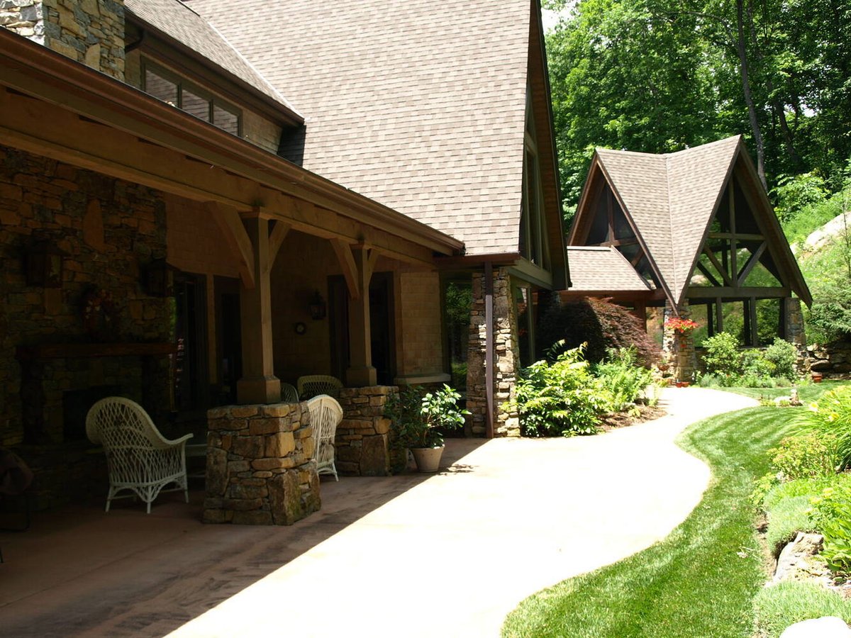 Shaded patio and timber beams on mountain home by Kaizen Homes in Swannanoa, NC