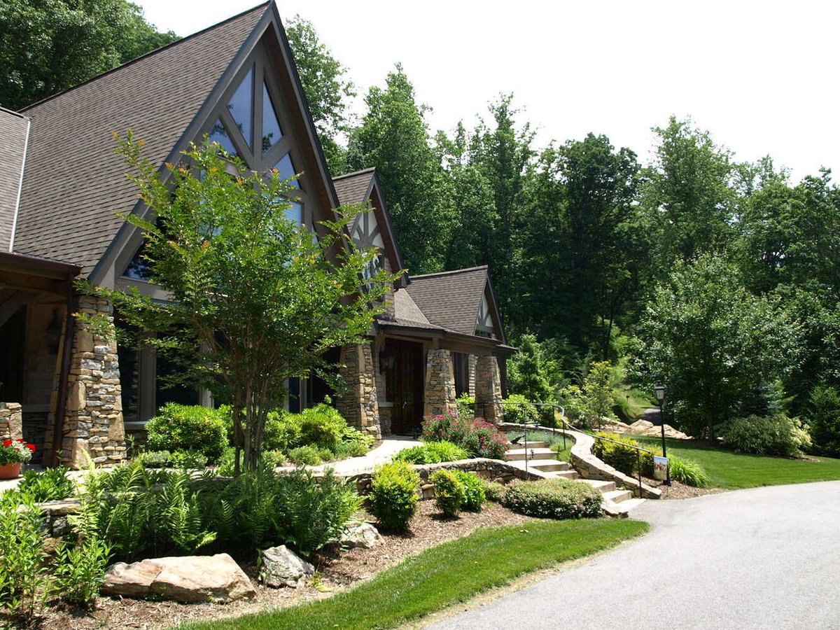 Stone entry and lush landscaping on custom home by Kaizen Homes in Asheville, NC
