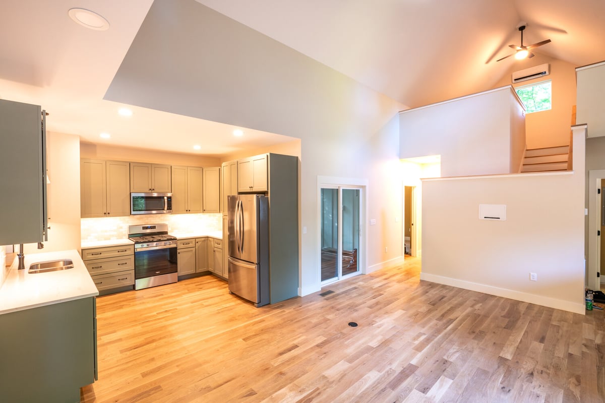 Contemporary home interior with vaulted ceilings and gourmet kitchen by Kaizen