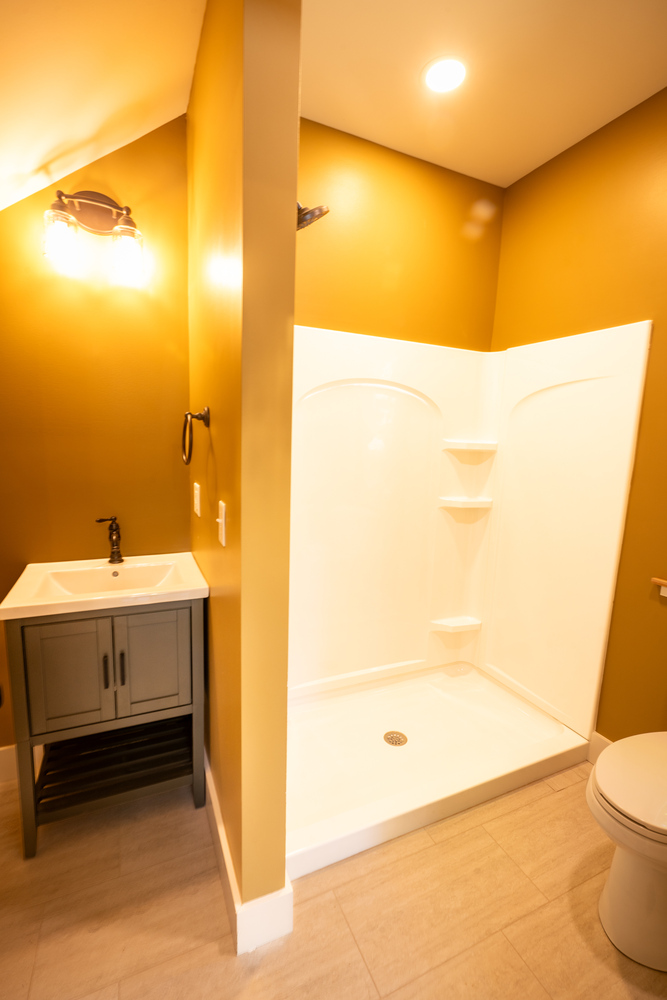 Kaizen Homes custom bathroom featuring minimalist design and warm wall tones