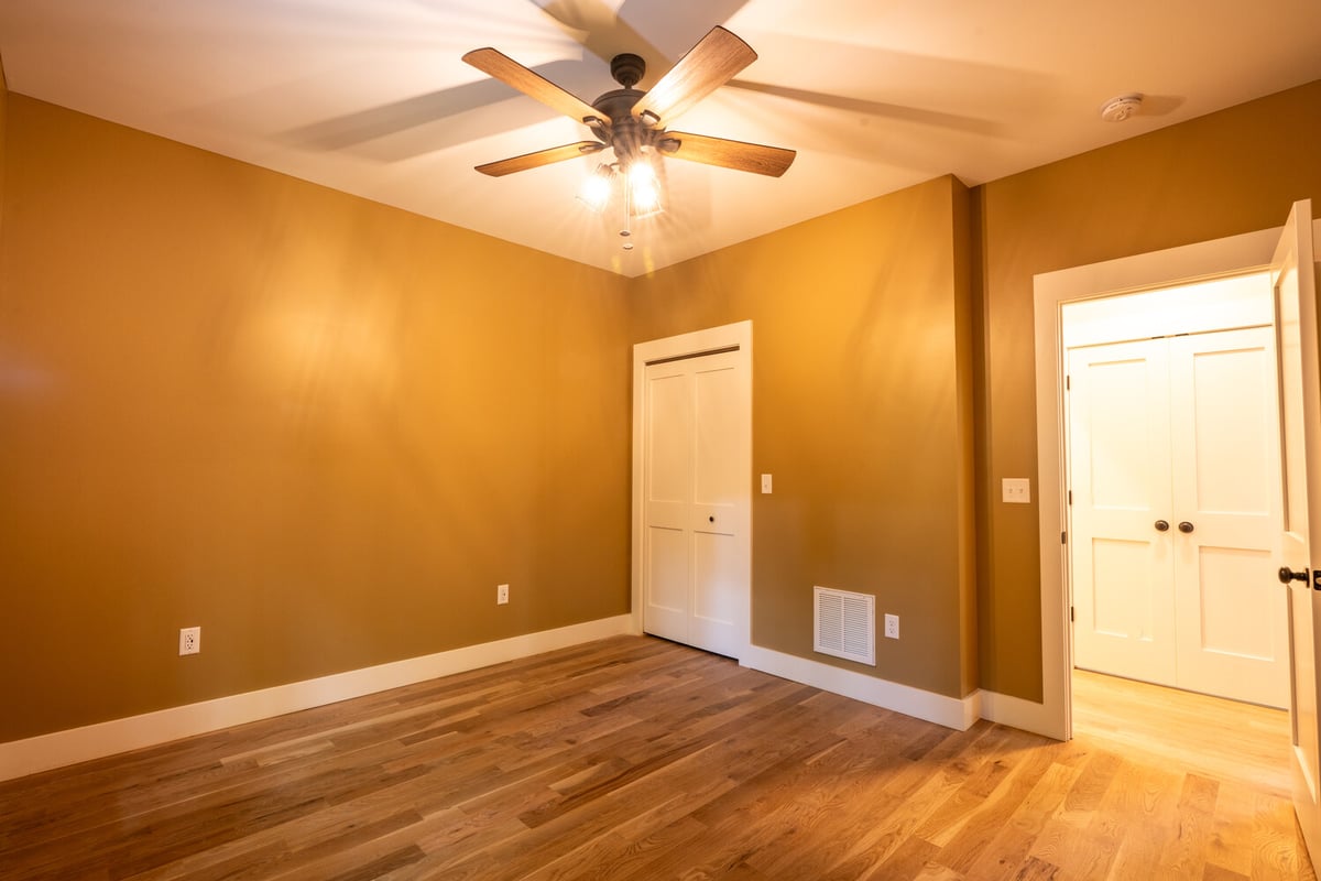 Kaizen Homes custom bedroom with wood ceiling fan and closet in Black Mountain, NC