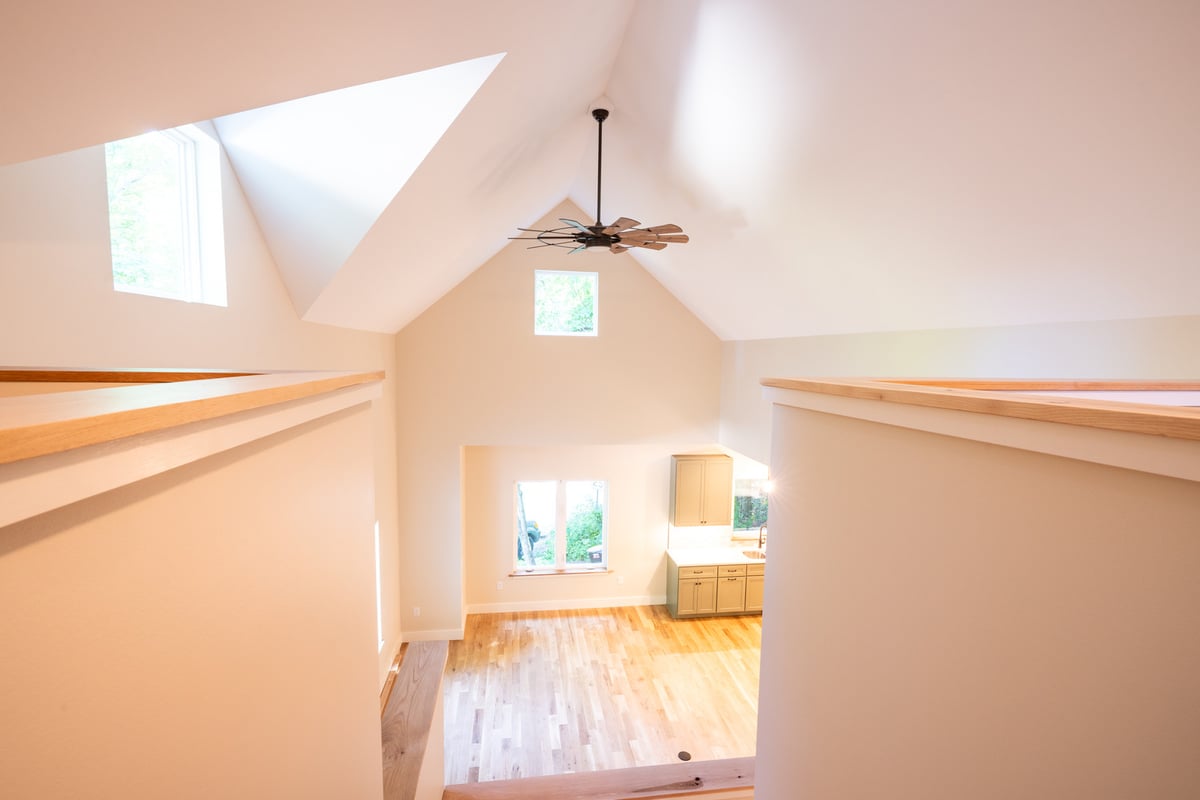 Main living area with large windows and modern ceiling fan in a Black Mountain, NC