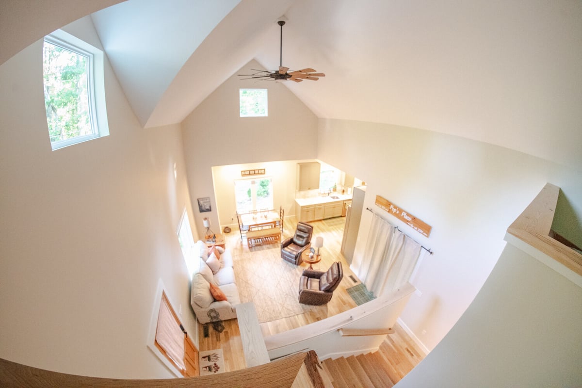 View of living and dining space with vaulted ceilings in Kaizen Homes custom home