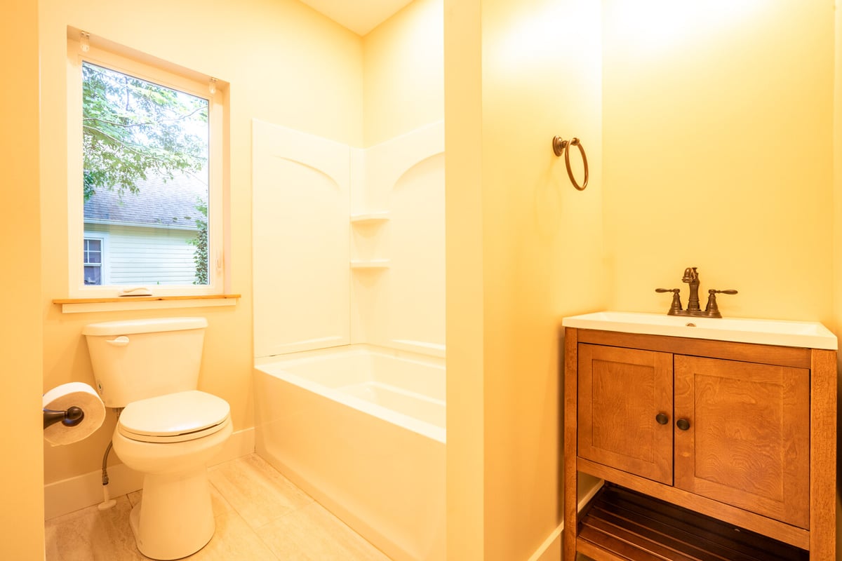 White tub and corner vanity in a Kaizen Homes bathroom in Black Mountain, NC
