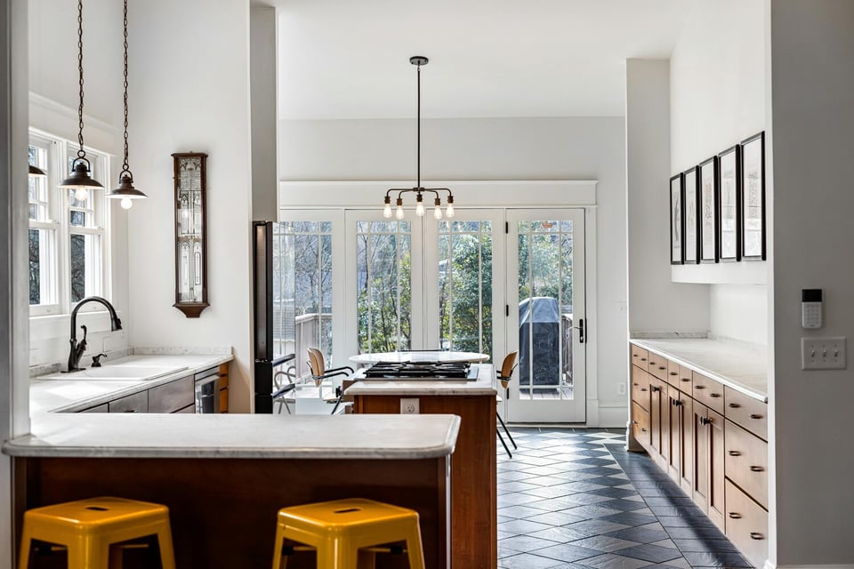 Transitional kitchen with natural wood cabinetry and bold floor tiles by Kaizen Homes in Black Mountain, NC
