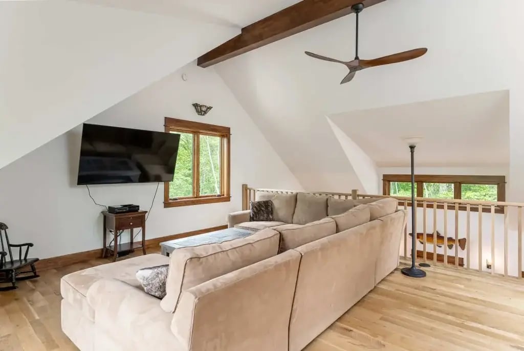 Another view of the loft with an exposed beam ceiling.