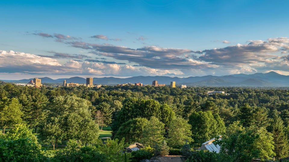 asheville nc land with view of mountains and downtown buildings in the distance