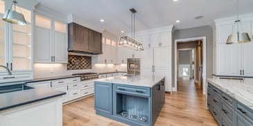 Open concept kitchen with blue island