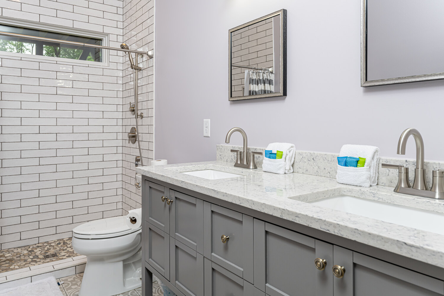 Custom bathroom remodel with double sink vanity and walk-in tiled shower by Kaizen