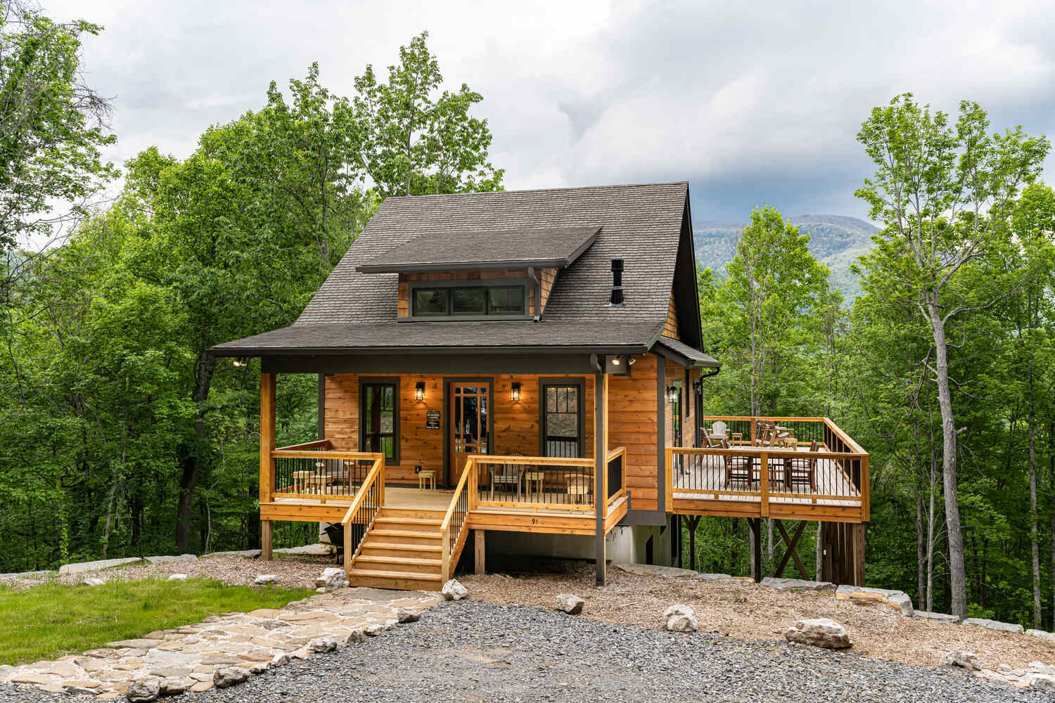 Rustic mountain retreat with spacious wooden deck built by Kaizen Homes in Fairview