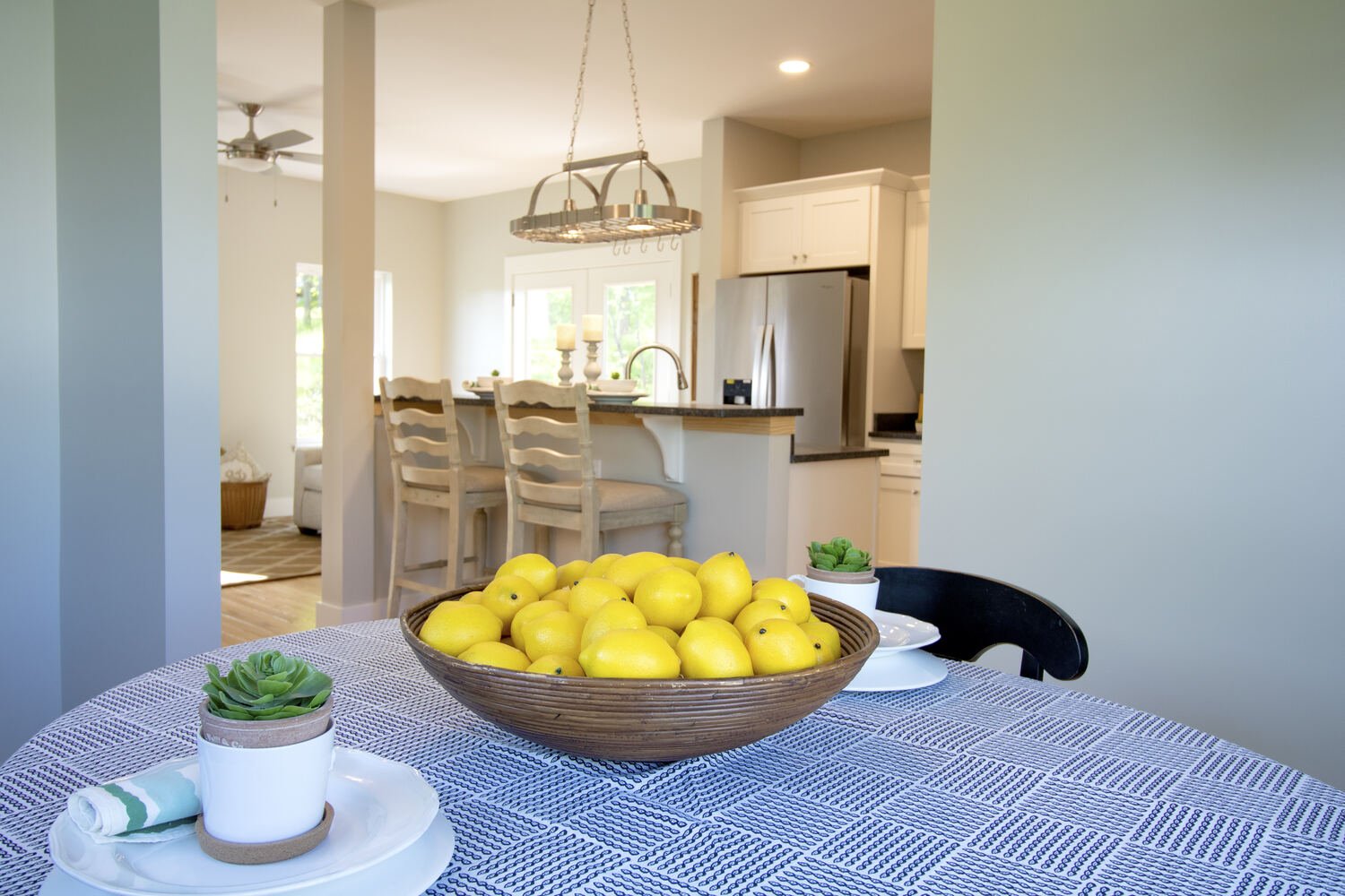 Open layout between dining and kitchen in a Canton, NC home by Kaizen Homes