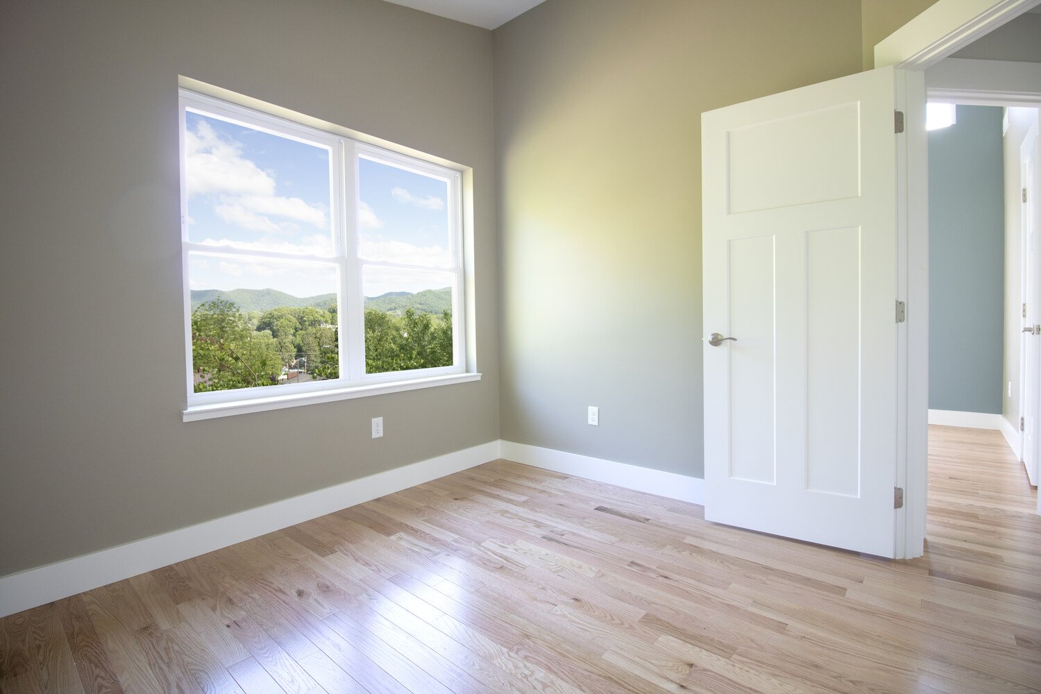 Peaceful natural-light-filled bedroom in Canton, NC by Kaizen Homes