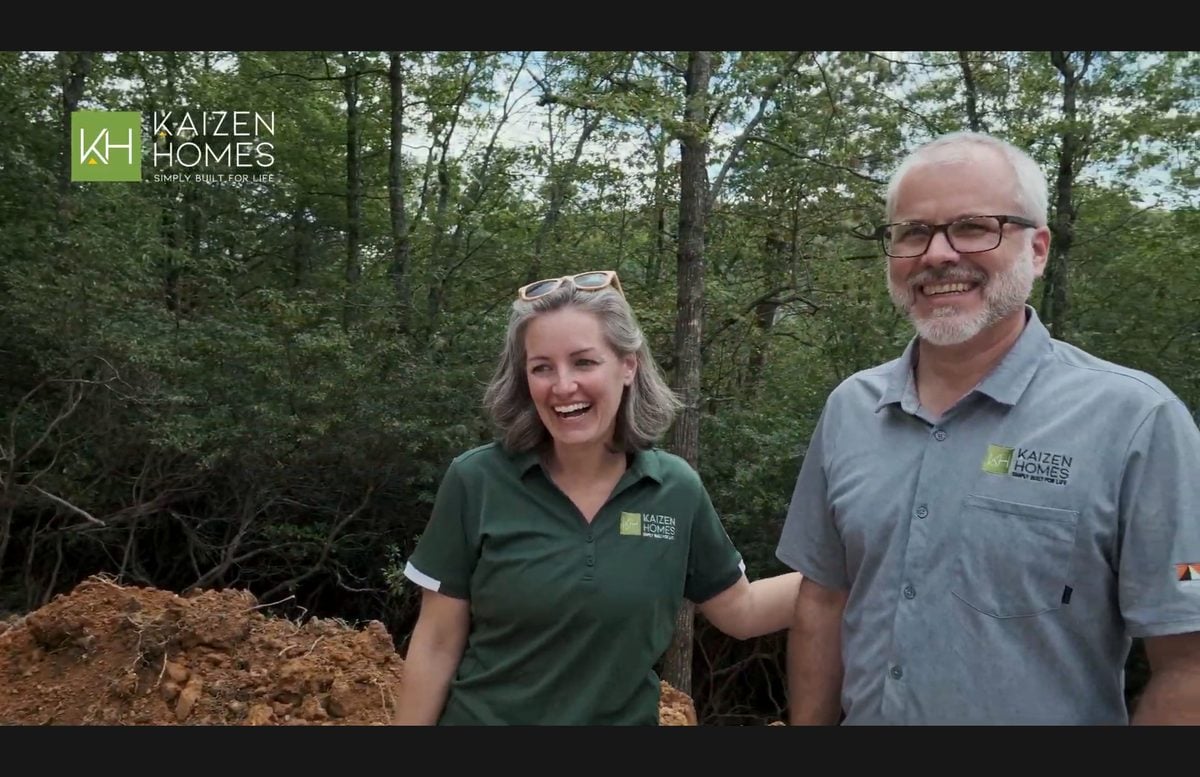 Jonathan Landry and Kaizen Homes team evaluating a WNC mountain lot — red clay, wooded terrain
